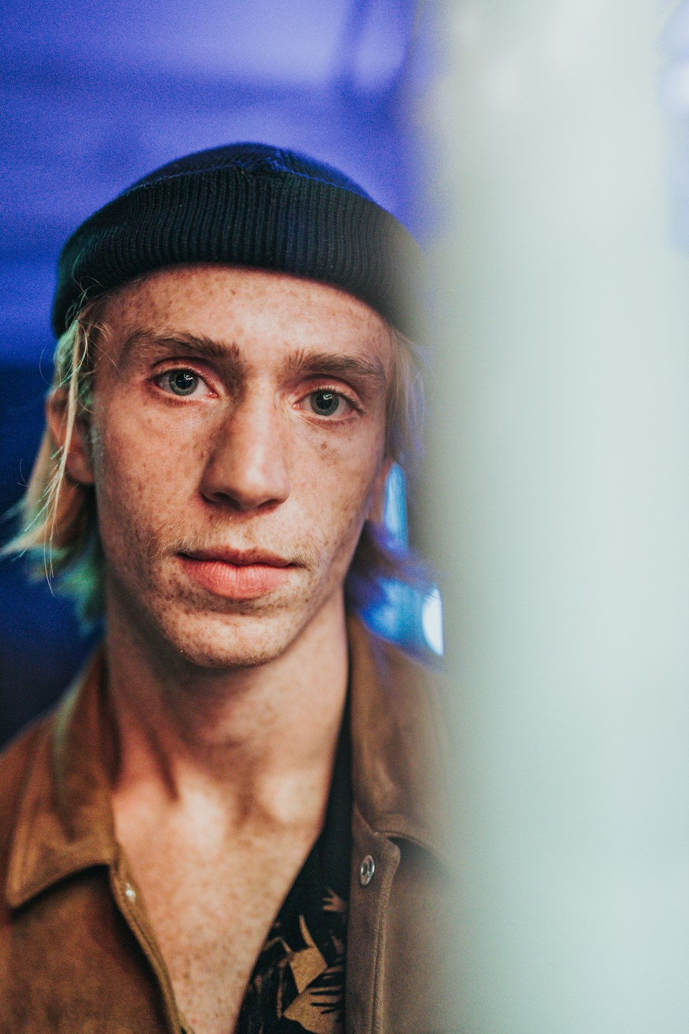 shallow focus photography of man in hat and leather jacket