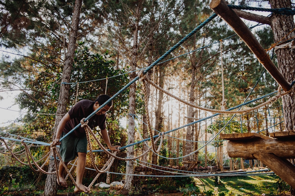 Photo d’un homme marchant sur un arbre de corde