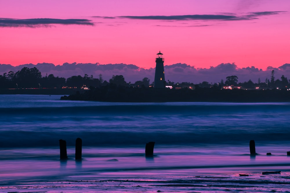 silhouette photo of lighthouse during golden hour