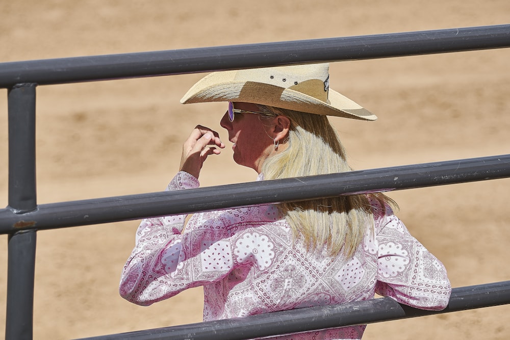 man wearing cowboy hat and floral top