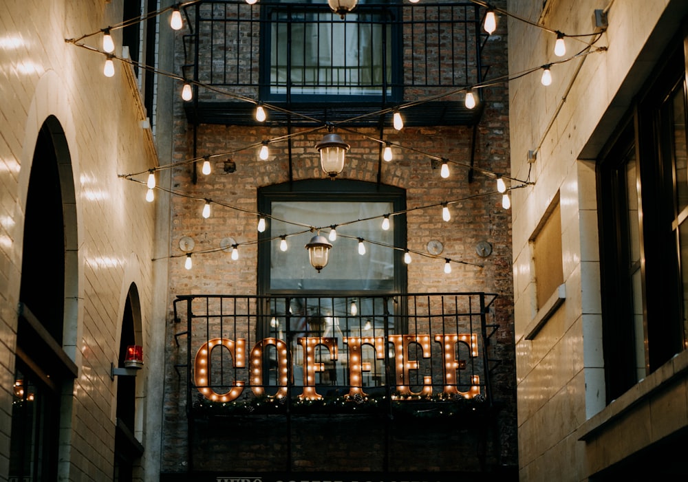 brown Coffee LED signage between buildings