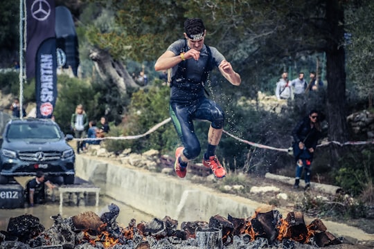 man jumping on flaming charcoal in Majorca Spain