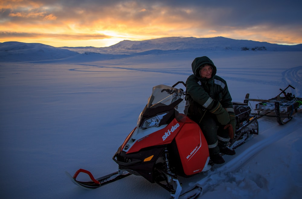 person sitting on snowmobile