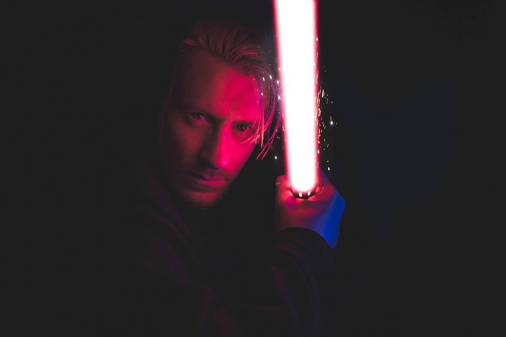 person holding red lightsaber