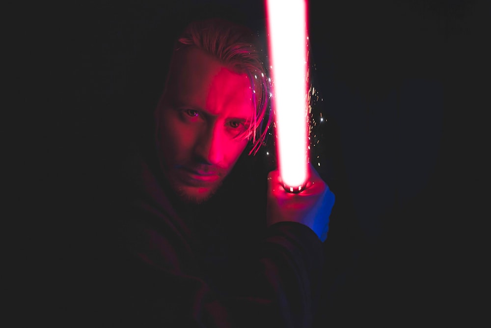 person holding red lightsaber