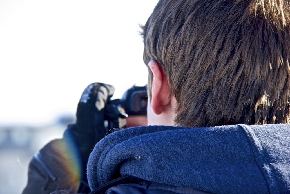 closeup photo of man holding camera