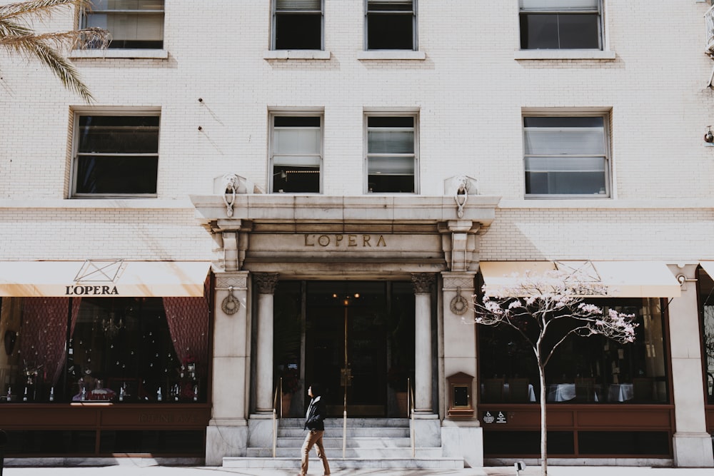 person walking on road near building