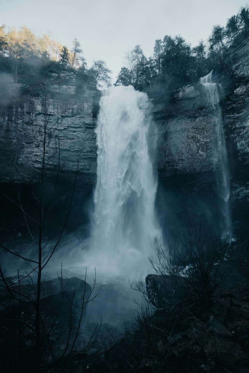 time-lapse photography of waterfalls under white clouds