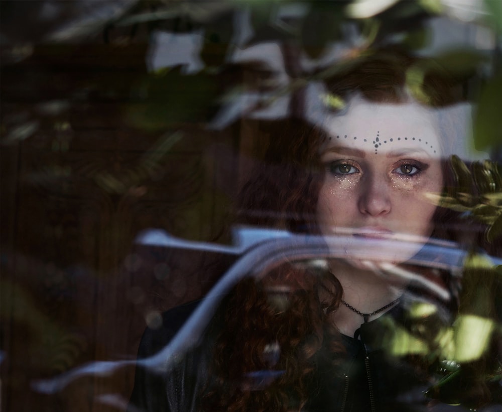 woman looking at glass during daytime