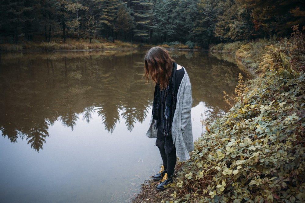 woman standing near body of water