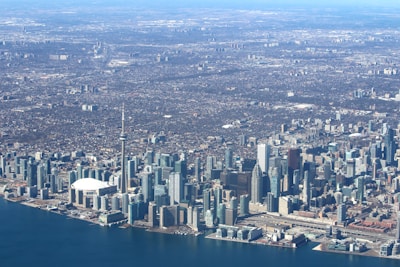 Aerial view of the Shahrukhz tower surrounded by Dubai’s waterfront and skyline.