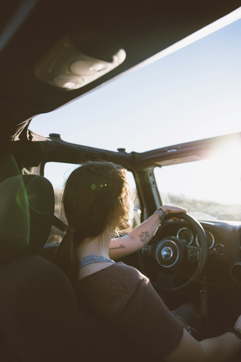 woman holding steering wheel while driving