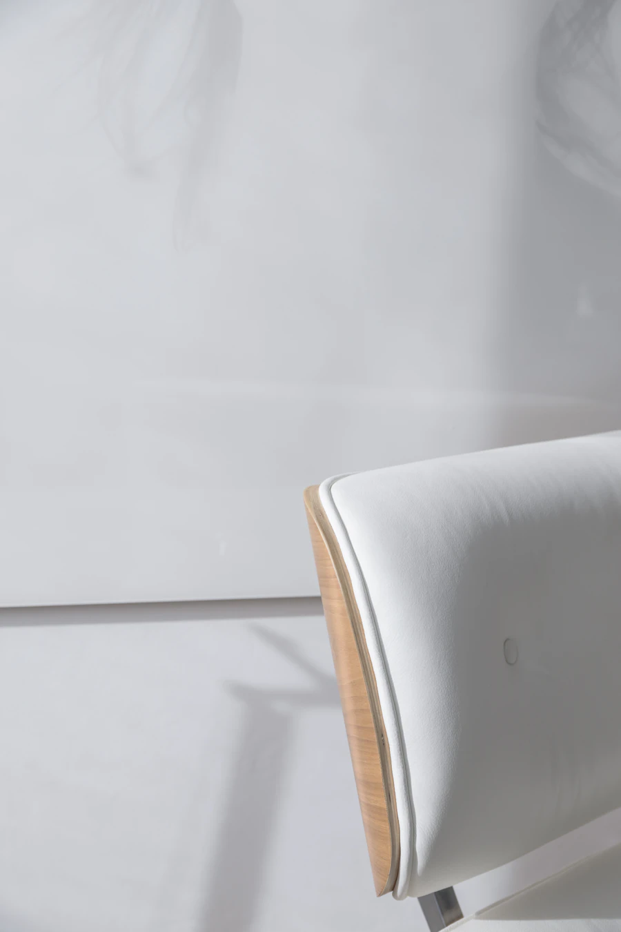 A considered lounge chair with a wooden backrest