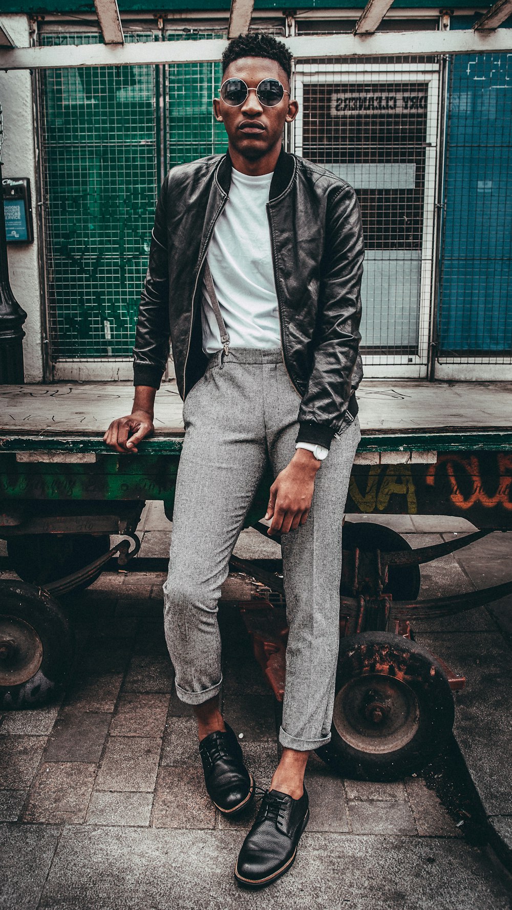 someone a man in black jacket posing with a good fashion sense