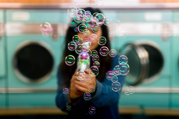Modern washing machine with bubbles floating around.