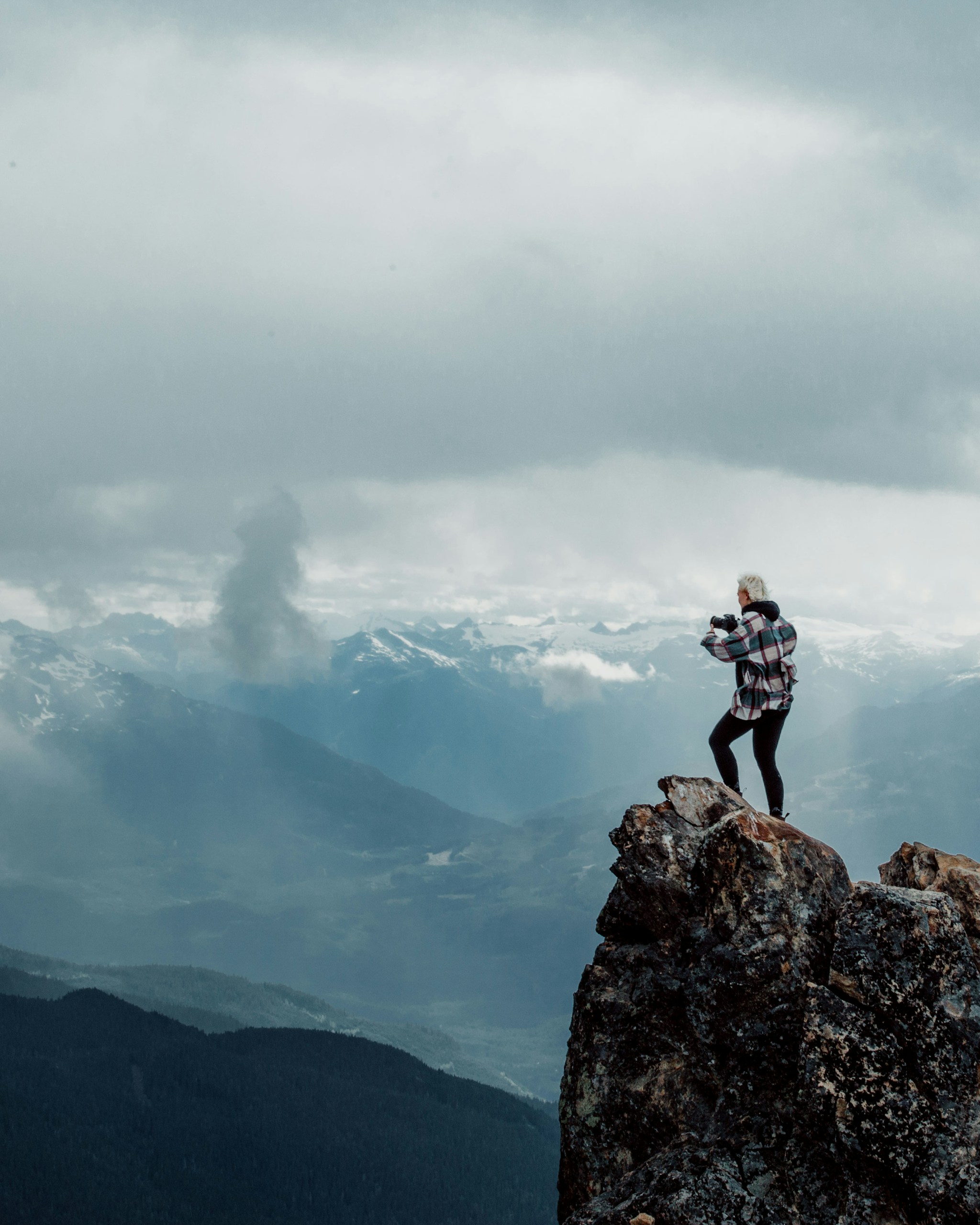 person standing on top of rock mountain during daytime