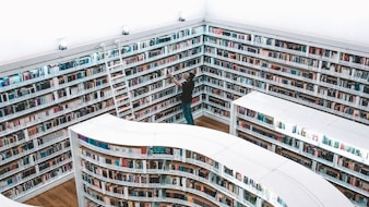 man looking book inside library