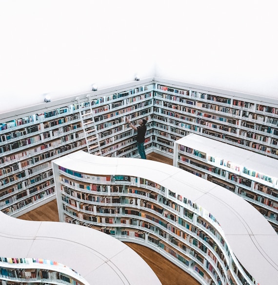 man looking book inside library