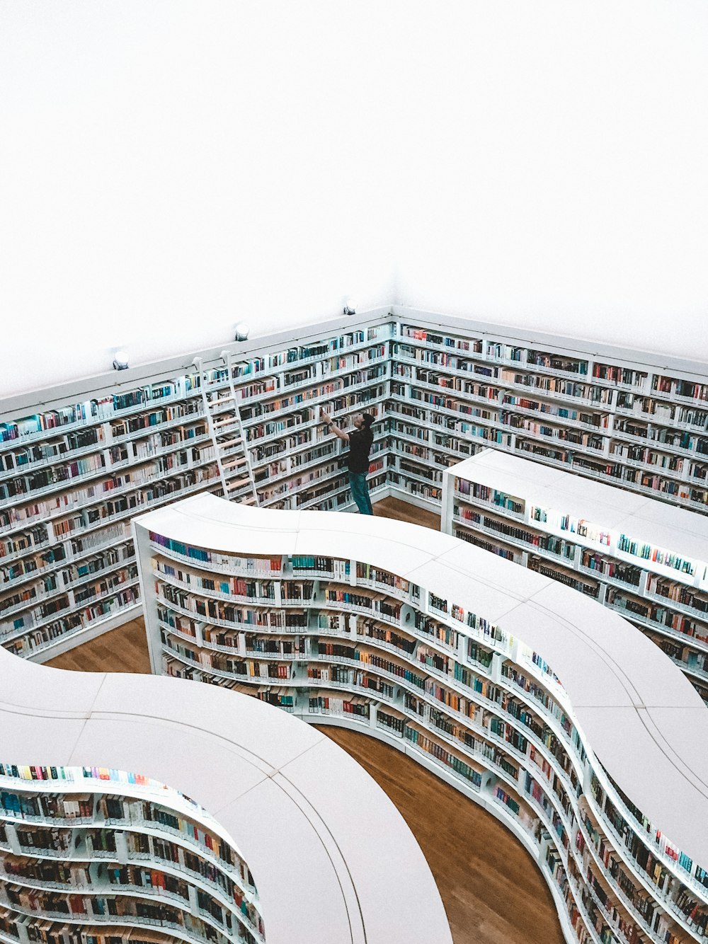 man looking book inside library