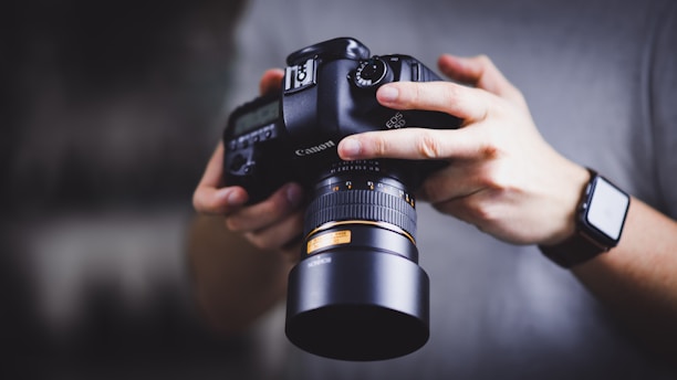Close-up of photographer holding a Canon DSLR camera for real estate shoot