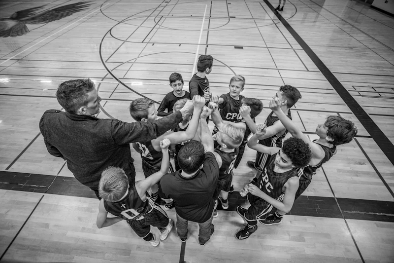 A youth team putting their hands together in a huddle