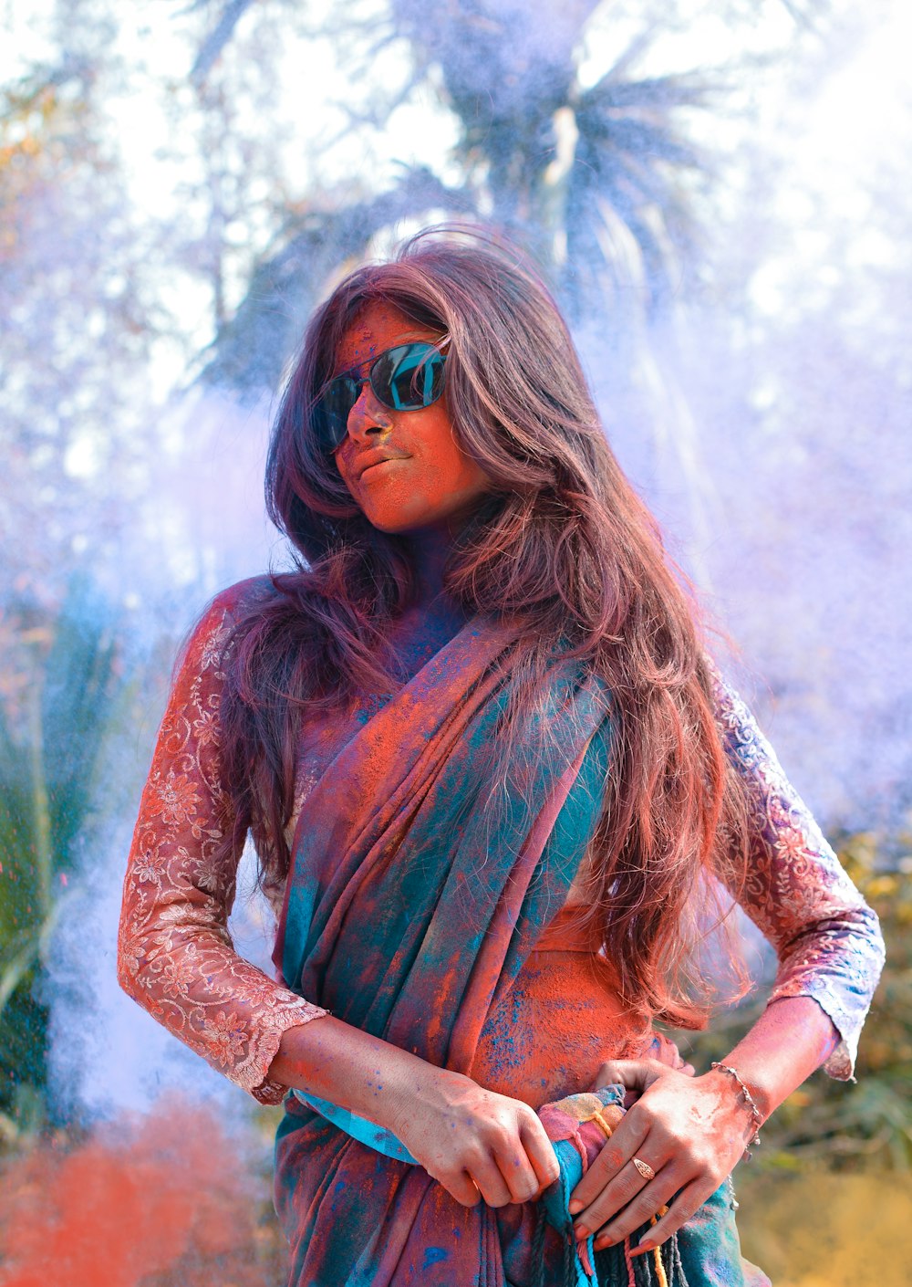 selective focus photo of woman wearing green and brown shawl covered with powder