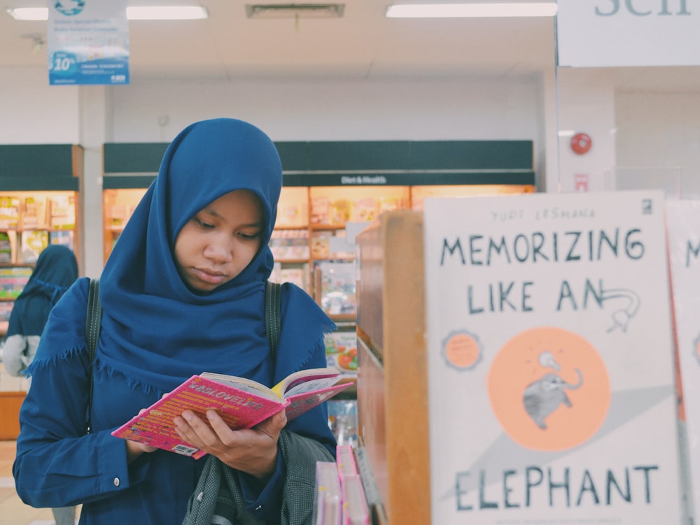 woman reading book inside book store