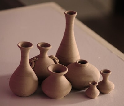 white clay vases on table pots zoom background