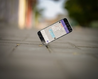 selective focus photo of iPhone balance on brick pavement