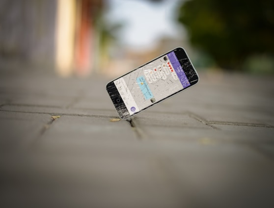 selective focus photo of iPhone balance on brick pavement