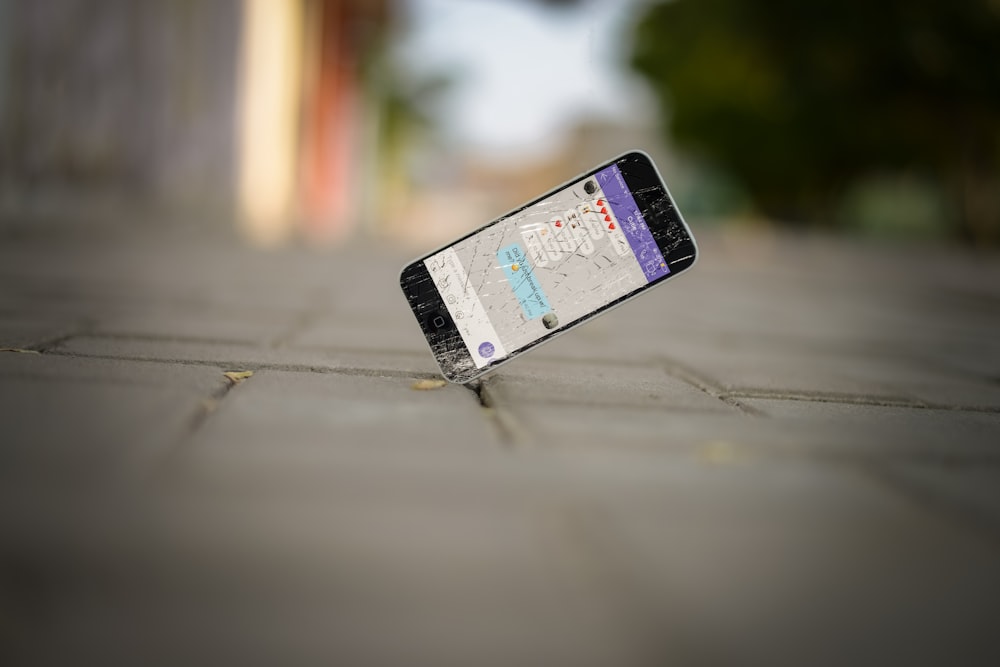 selective focus photo of iPhone balance on brick pavement