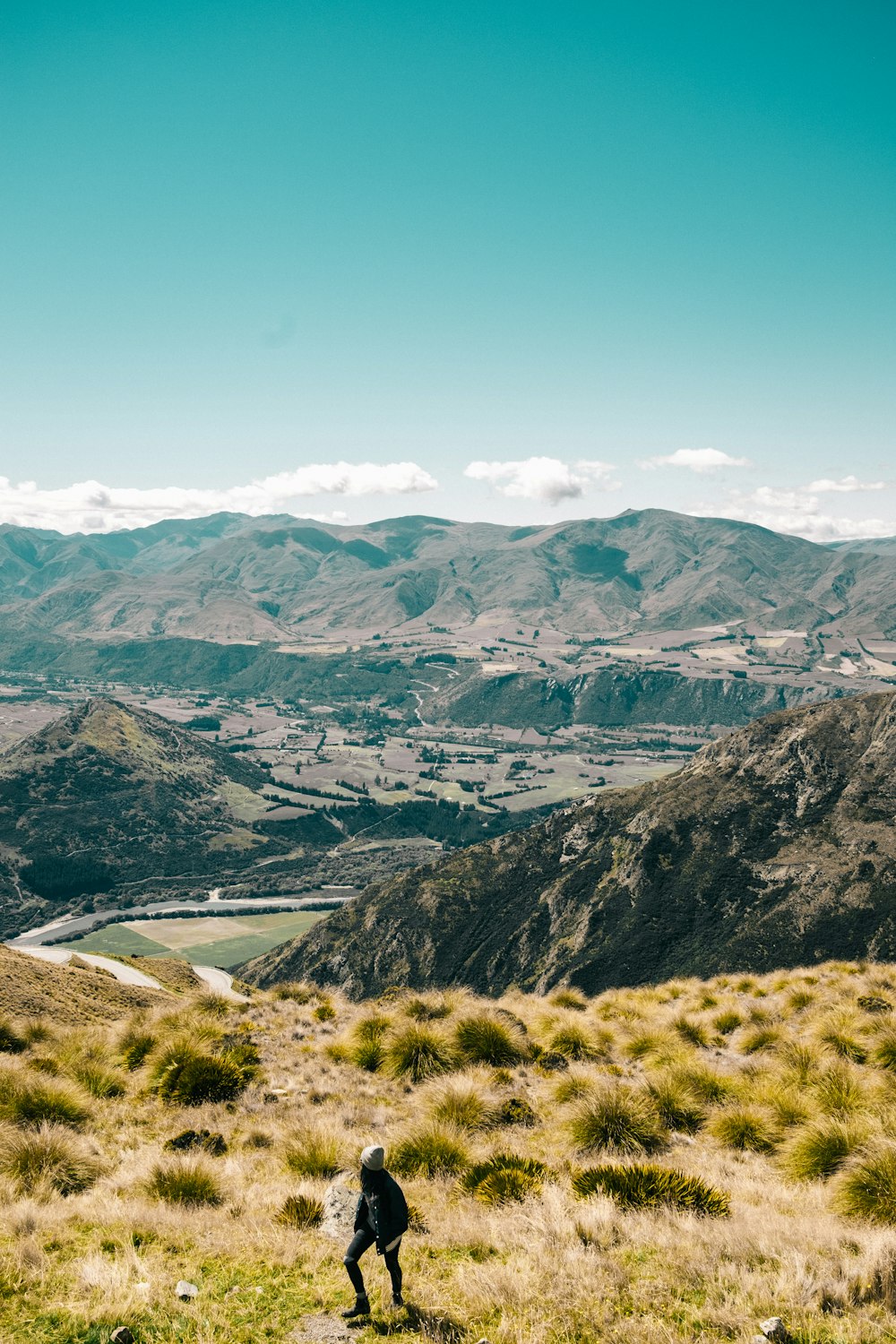 woman hiking on brown mountain