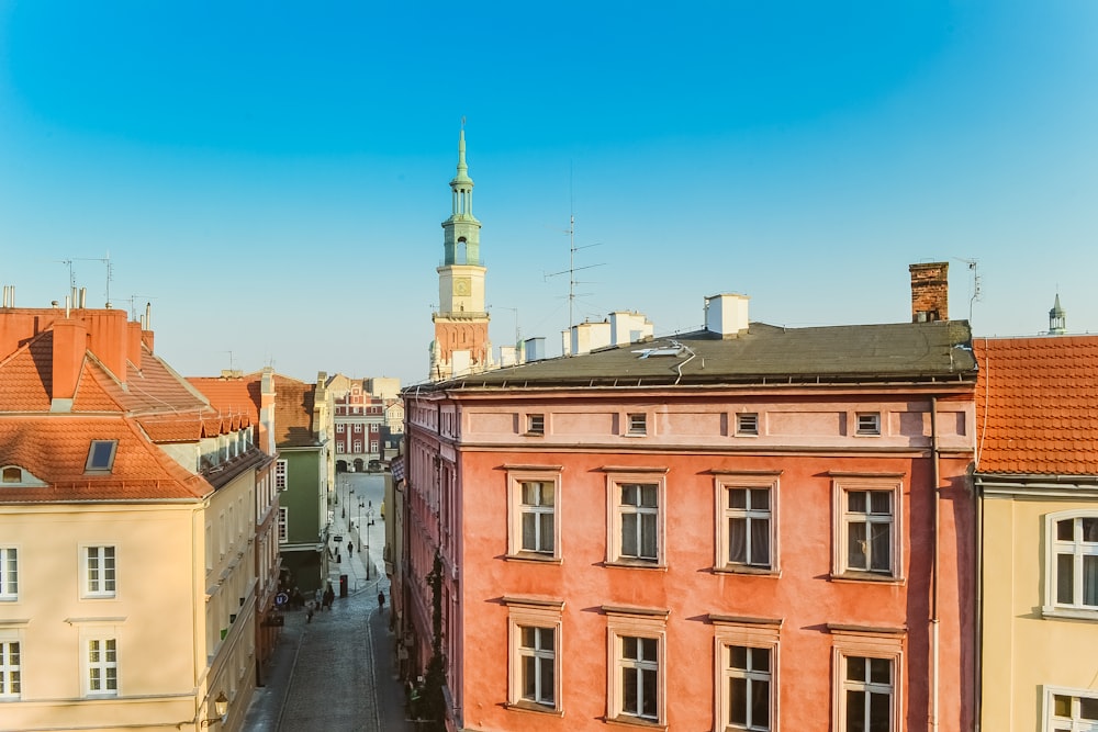 pink concrete buildings with narrow path at daytime