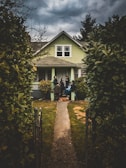 people standing near closed door house