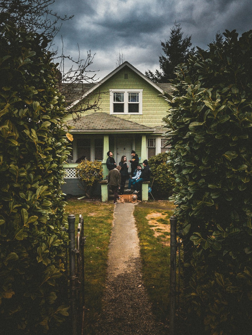 people standing near closed door house