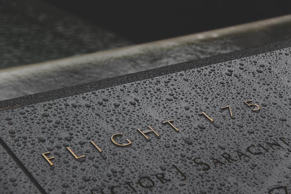 a close up of a plaque with water drops on it