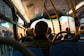 photo of man sitting inside bus