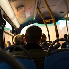 photo of man sitting inside bus