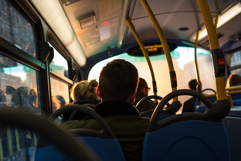 photo of man sitting inside bus