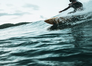 man surfboarding during daytime