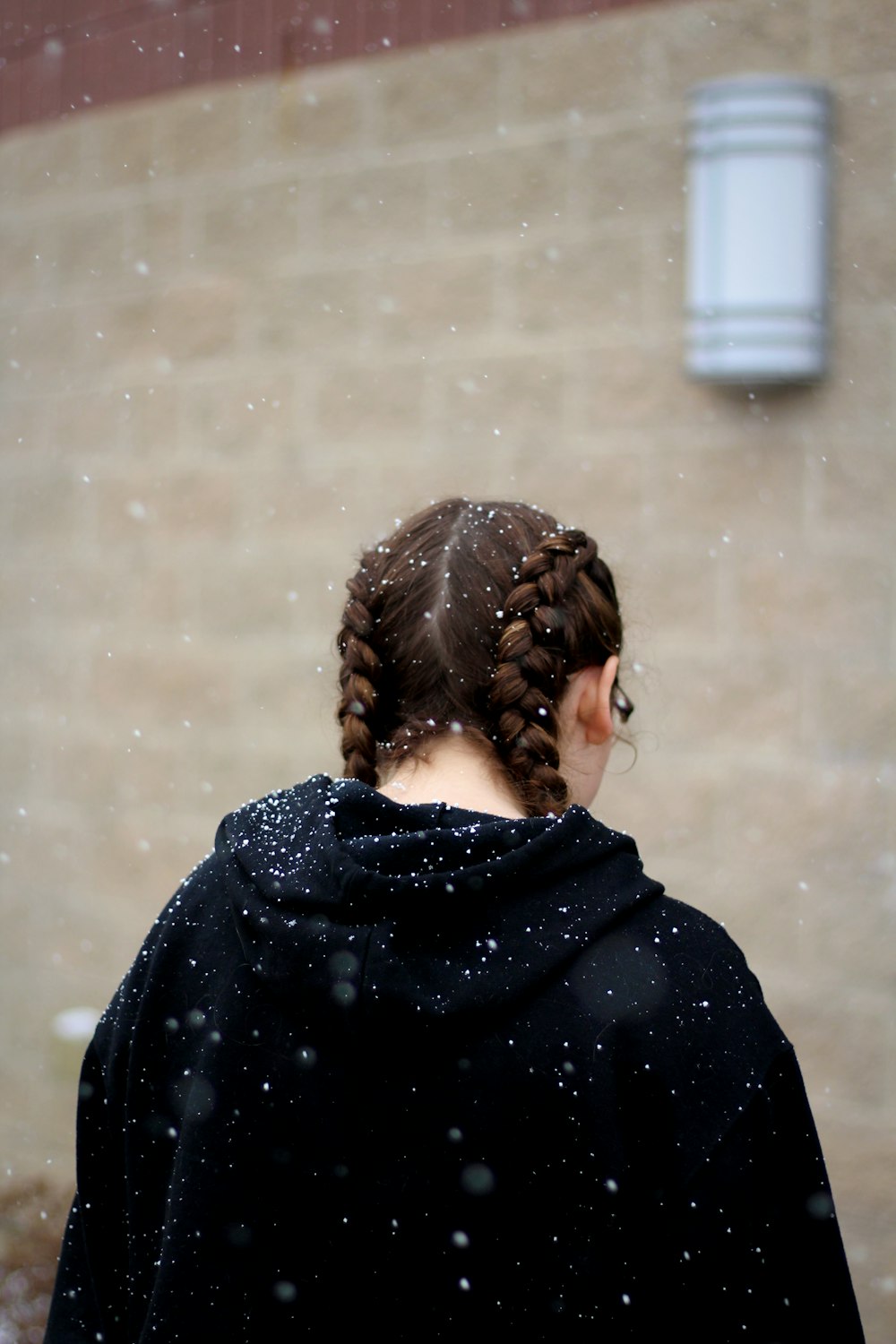 selective focus photography of woman wearing black hoodie