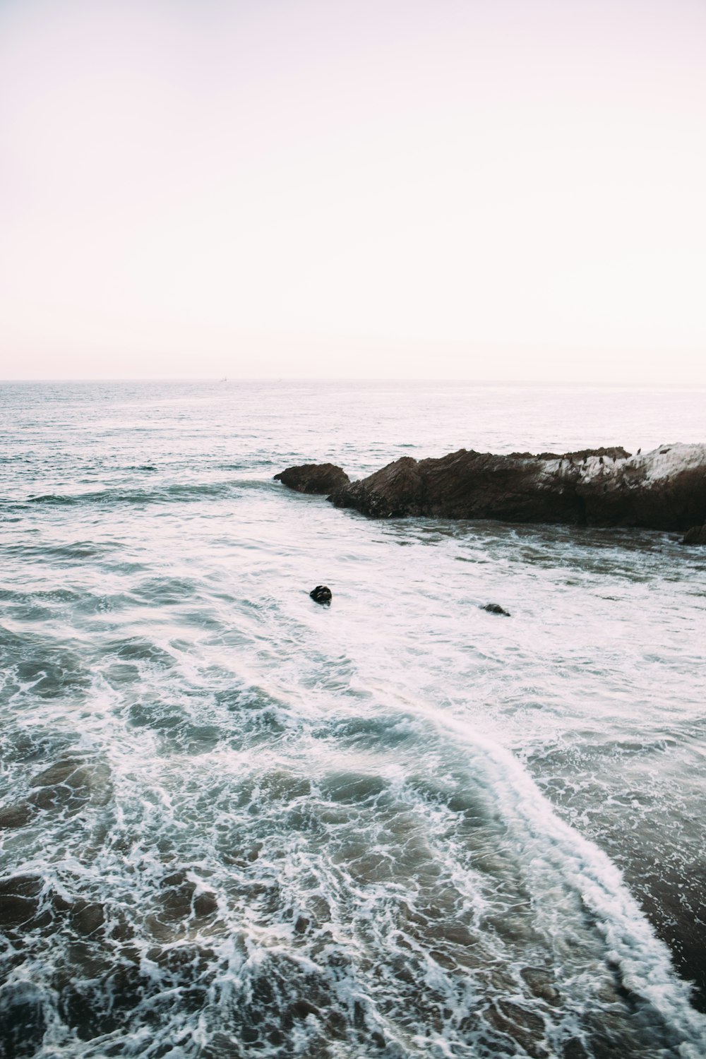 body of water under cloudy sky during daytime