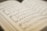 An open sheet music book displaying musical notations and lyrics. The pages are slightly blurred in the background, focusing on a section of the music with clearly visible notes and treble clef.