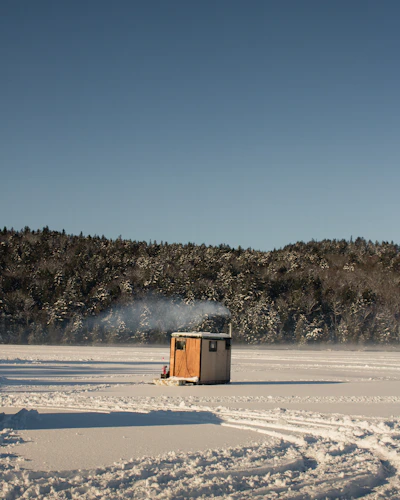 ice fishing shack on a frozen lake in winter