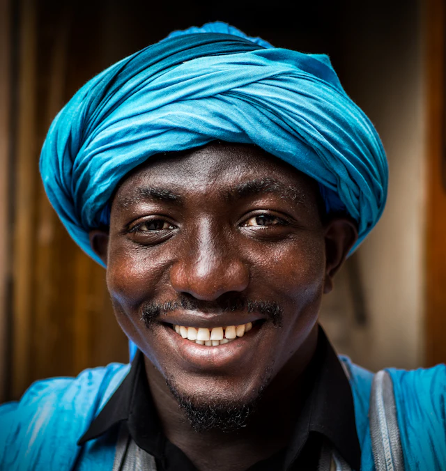 Portrait of a smiling man in a blue headwrap