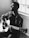 grayscale photography of man playing acoustic guitar