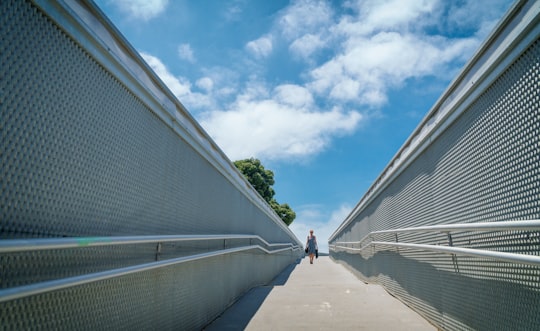 woman walking in the middle of concrete walls in Cádiz Spain