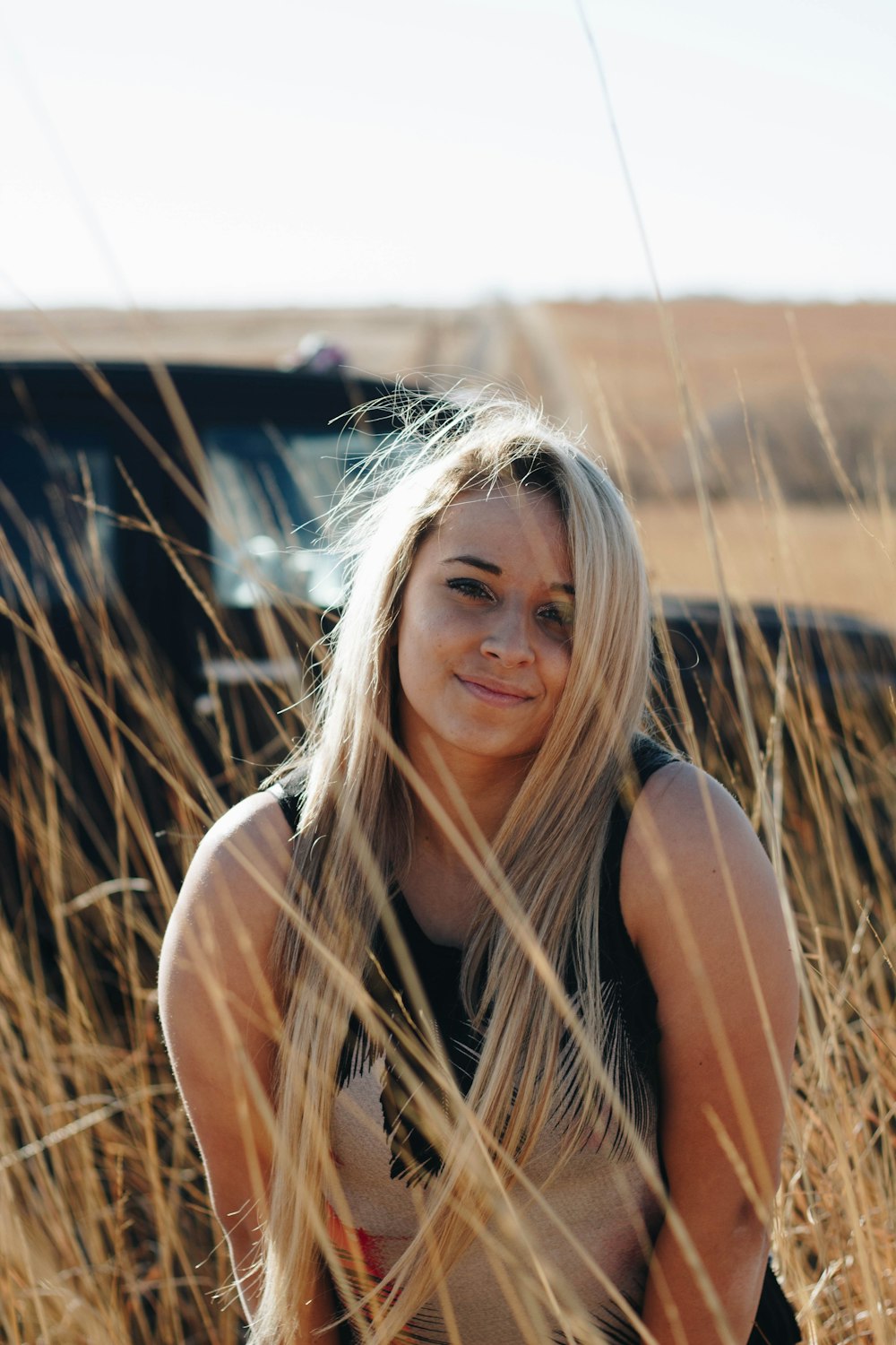 woman in brown grass field posing