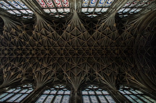 worm's-eye view of gray cathedral ceiling in Gloucester Cathedral United Kingdom