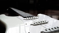 Close-up of a classic electric guitar with intricate fretboard inlays.